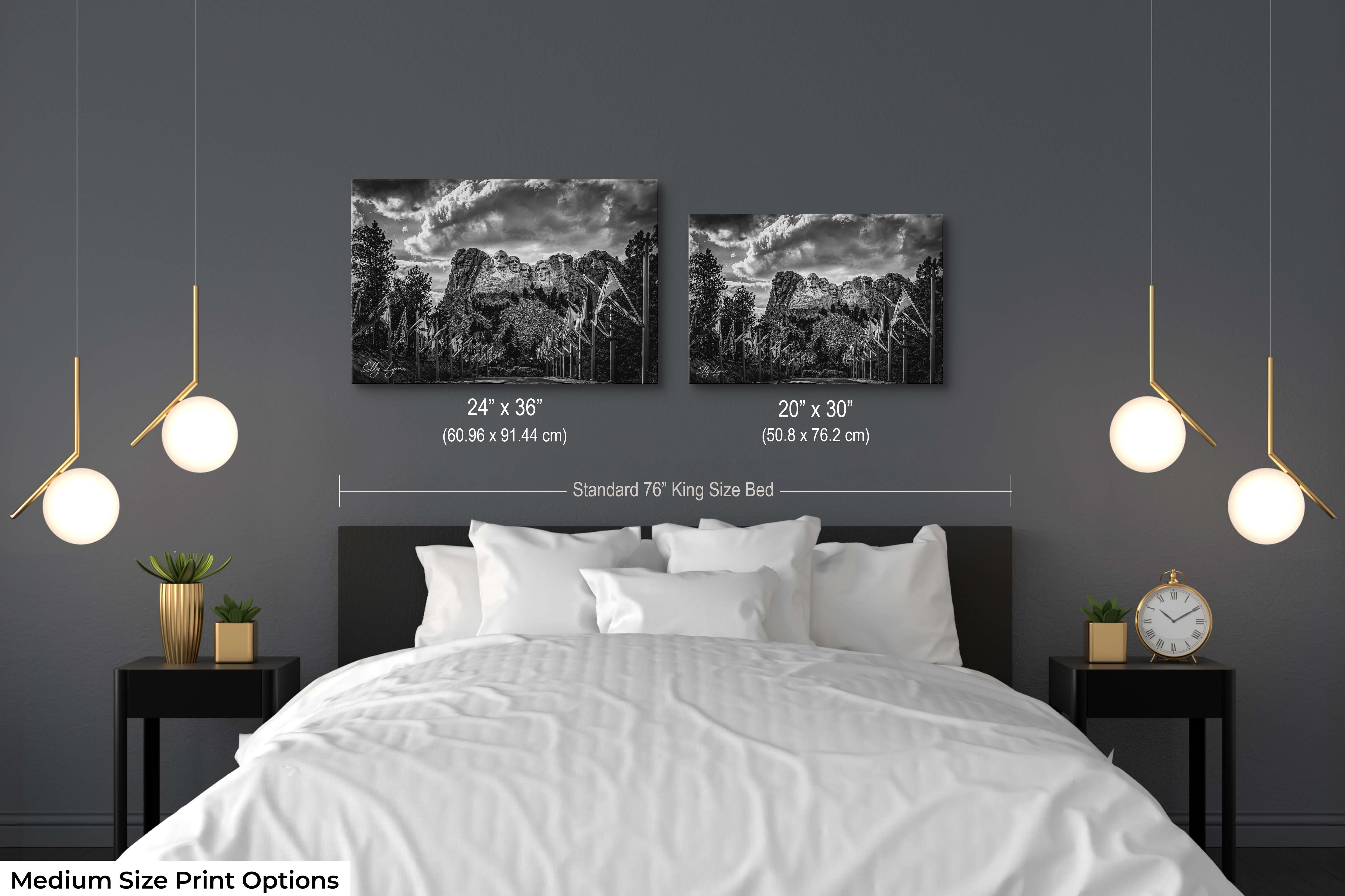 Two medium black and white Mount Rushmore fine art prints displayed above a modern stylized bed.