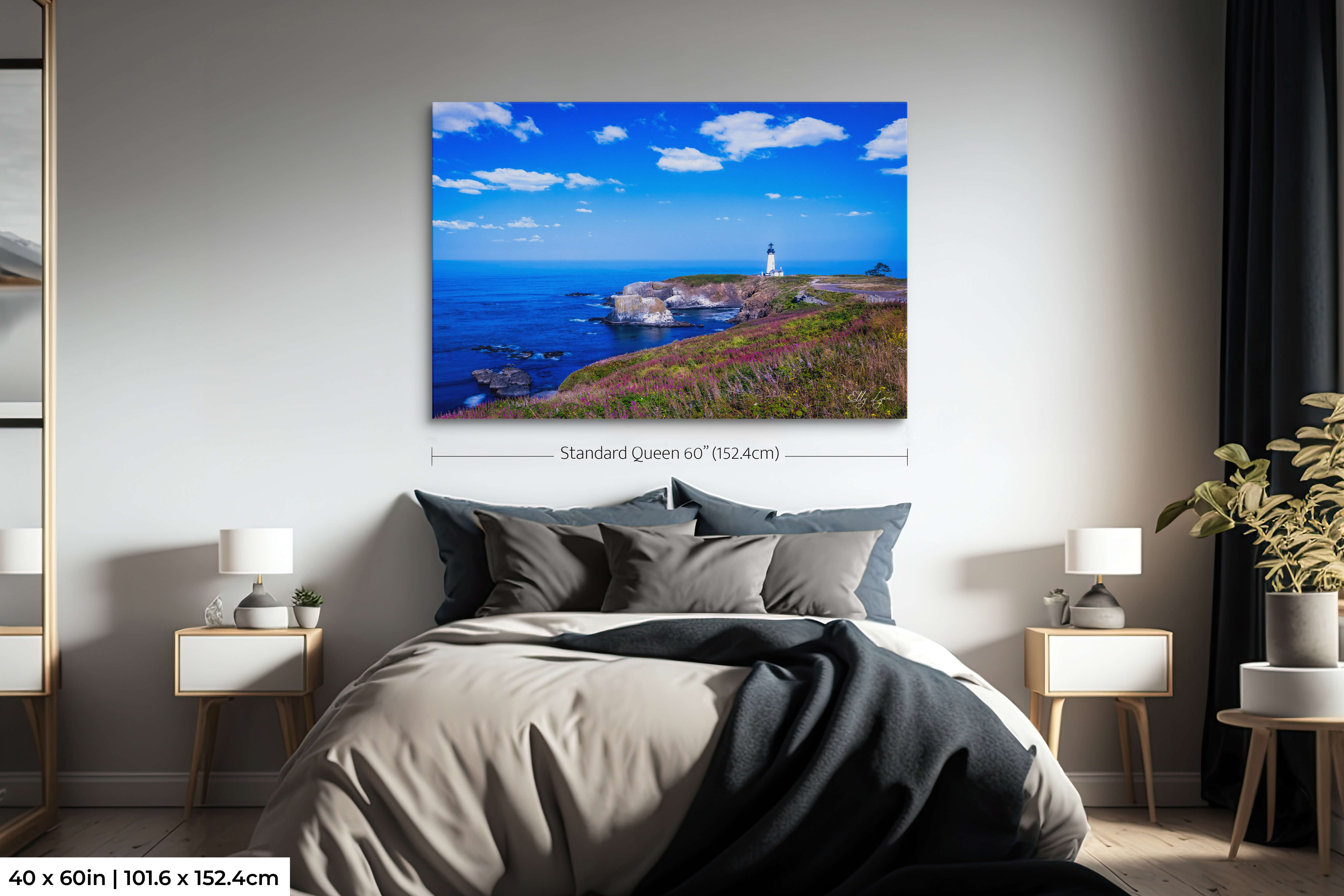 Oversized lighthouse artwork above a bed, anchoring the entire bedroom with coastal tranquility.