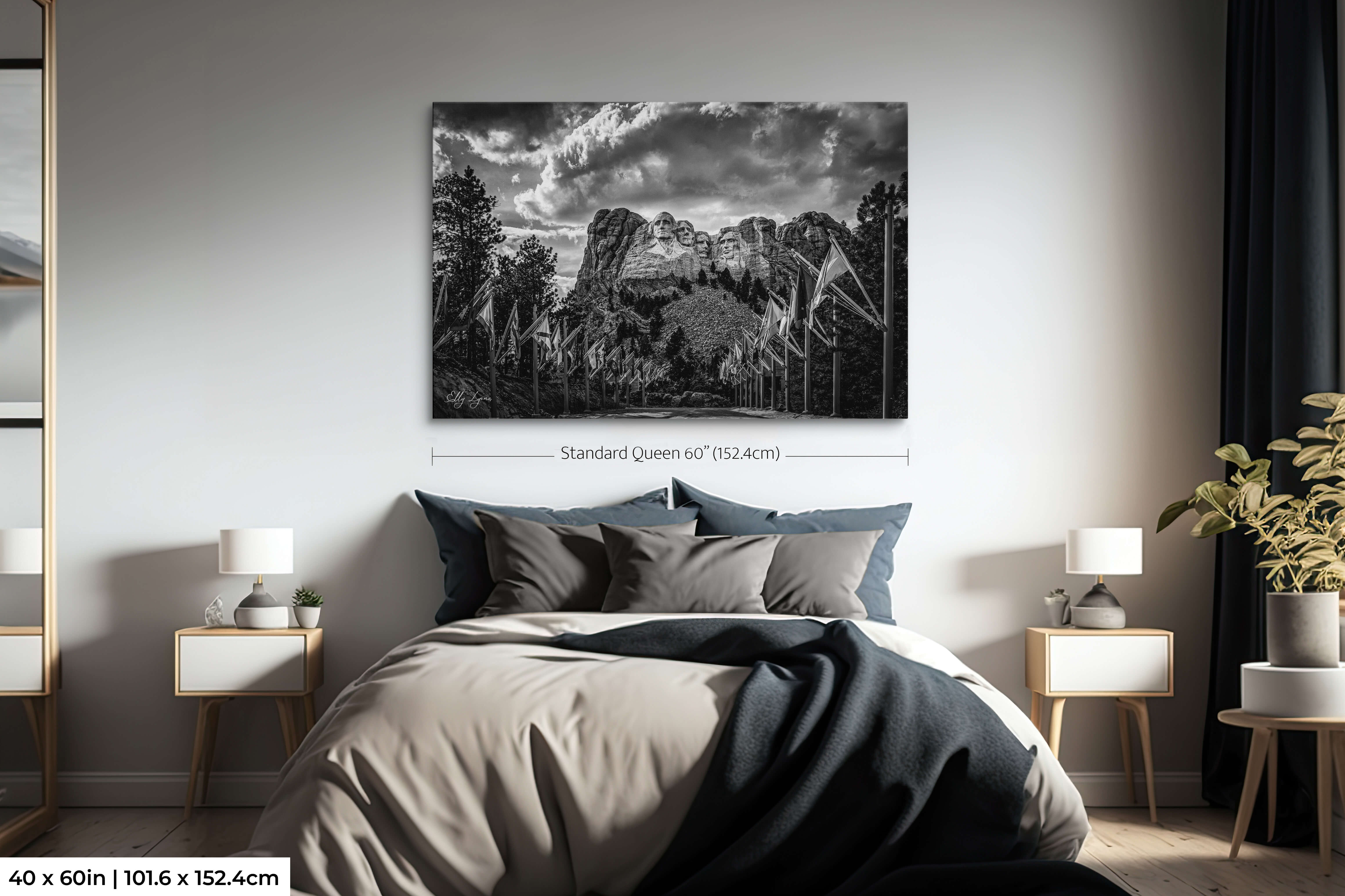 Extra large Mount Rushmore black and white photography print as a dramatic centerpiece above a bed in a serene bedroom.