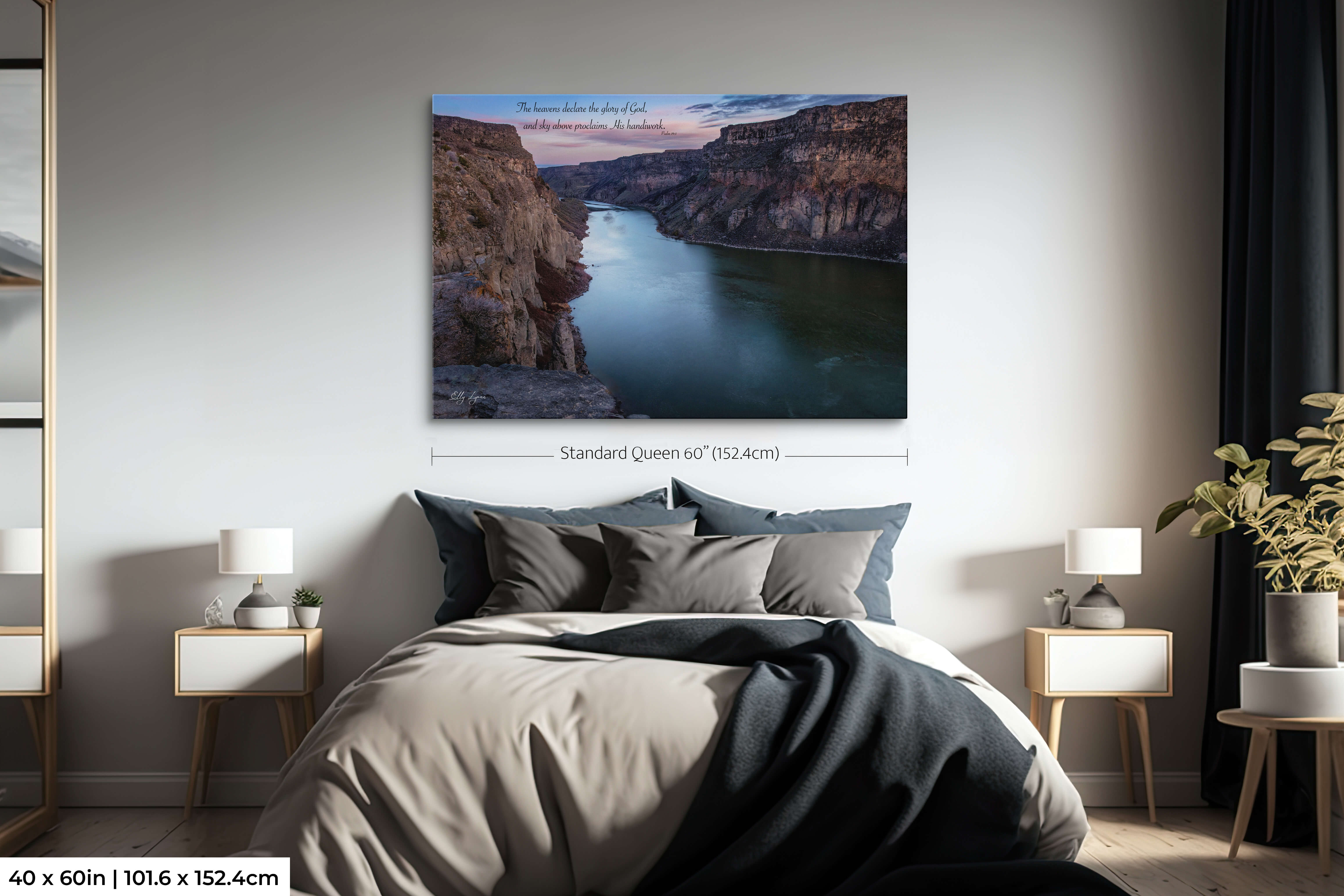 Oversized landscape print of Snake River Canyon with Psalm 19:1 scripture displayed above a large bed.
