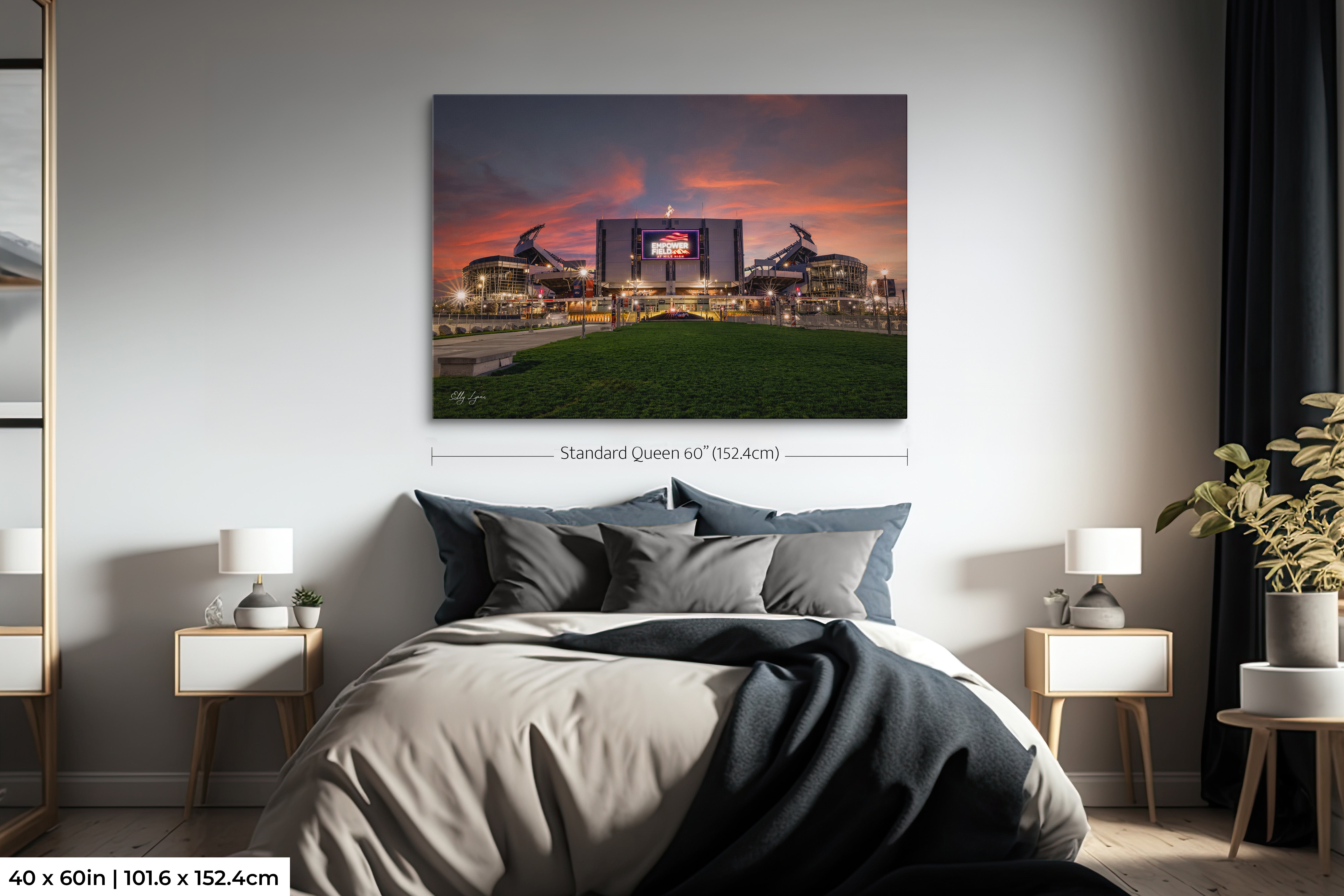 Empower Field at Mile High sunset wall art print extra large size of 40 by 60 inches styled over a queen sized bed in a cozy bedroom setting showcasing dramatic scale.