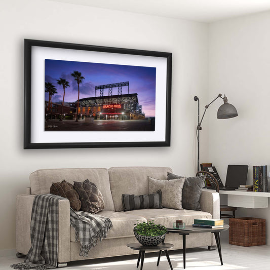 Oracle Park San Francisco Giants baseball stadium at blue hour sunset with purple pink sky, palm trees, Willie Mays statue, glowing stadium lights
