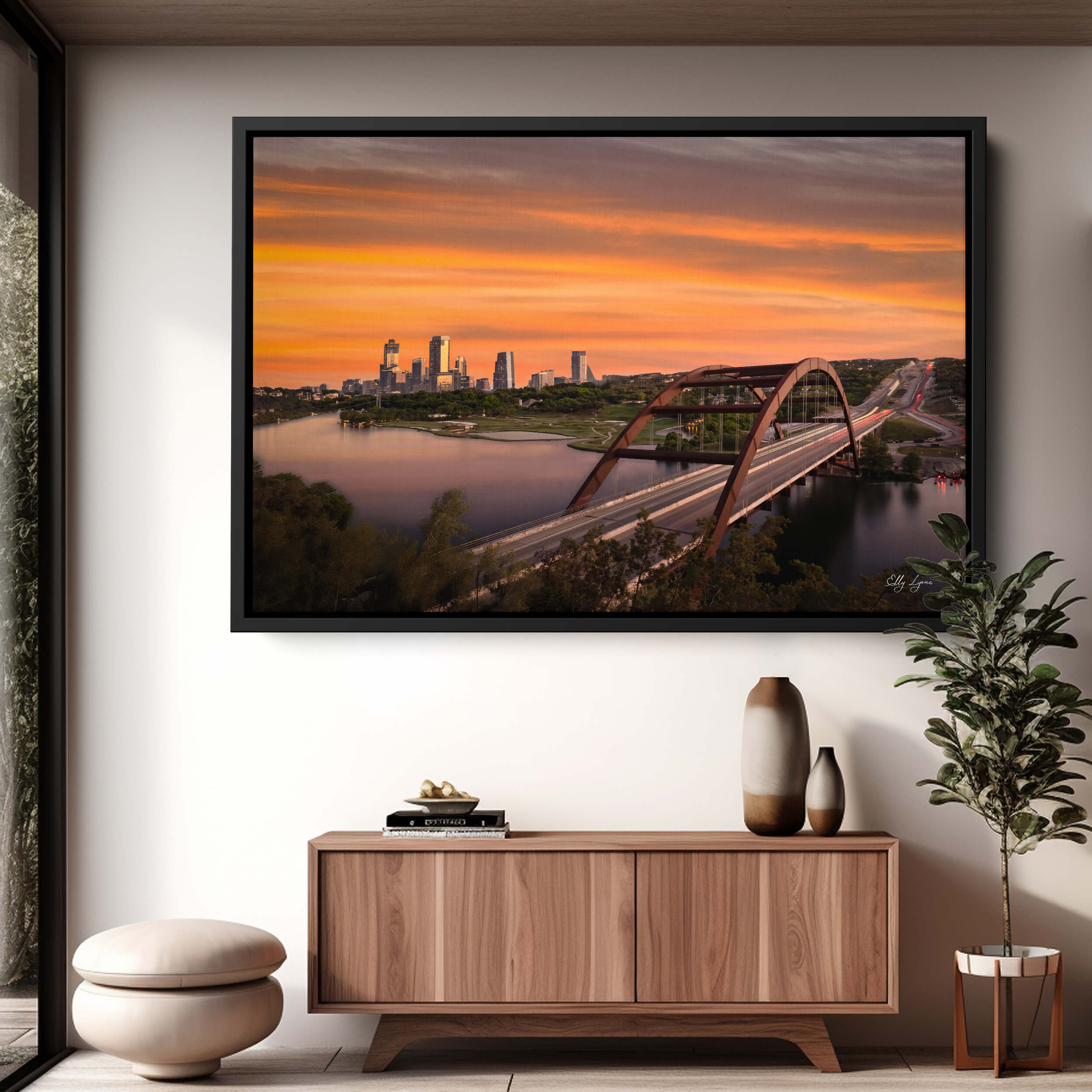 Pennybacker Bridge in Austin, TX, during a golden sunset casting warm light on the Colorado River and hill country below.