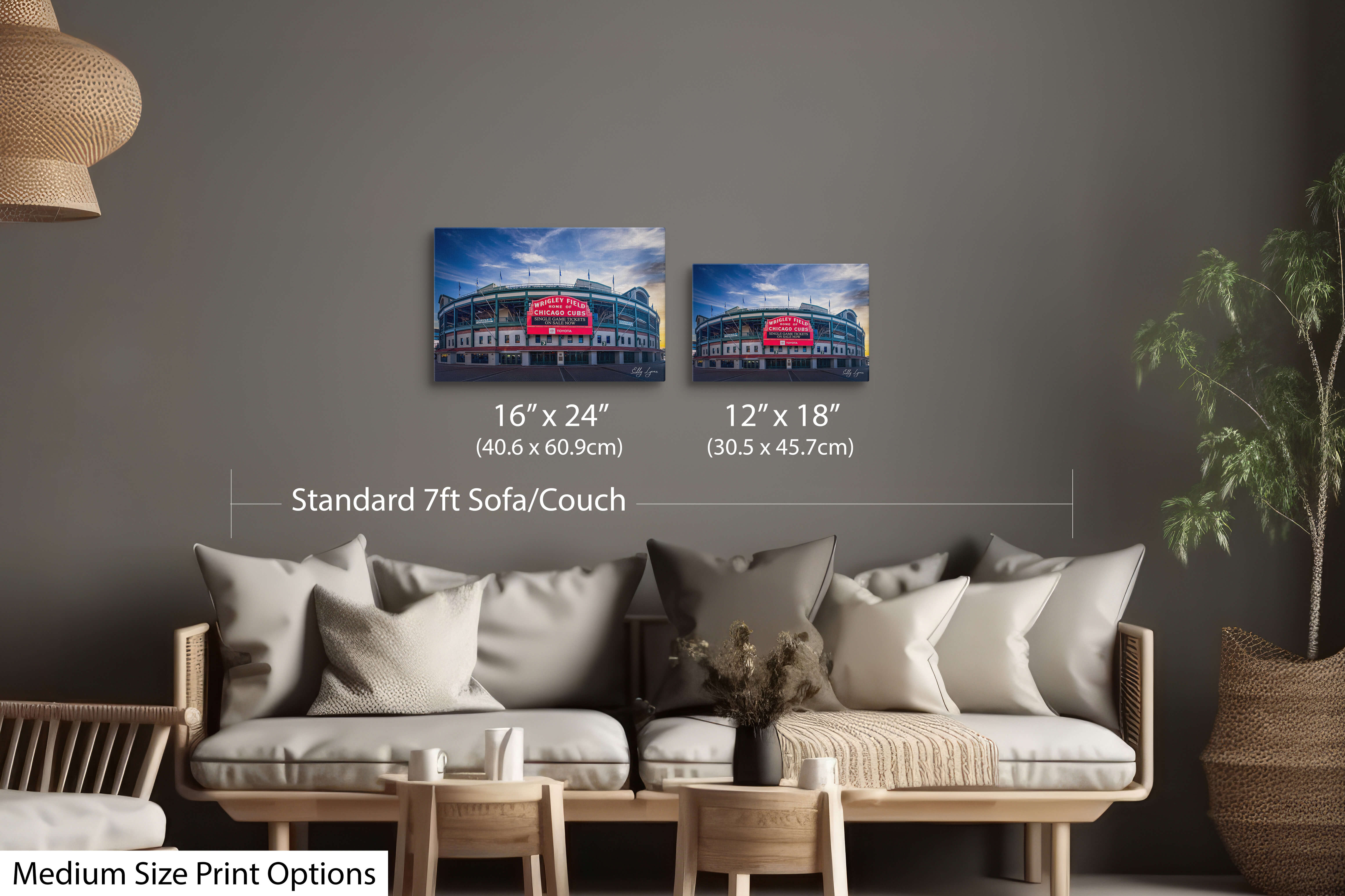 Wrigley Field sunrise wall art print displayed in 2 different print sizes of 12 by 18 inches and 16 by 24 inches styled over a standard couch/sofa showcasing size comparison and scale.